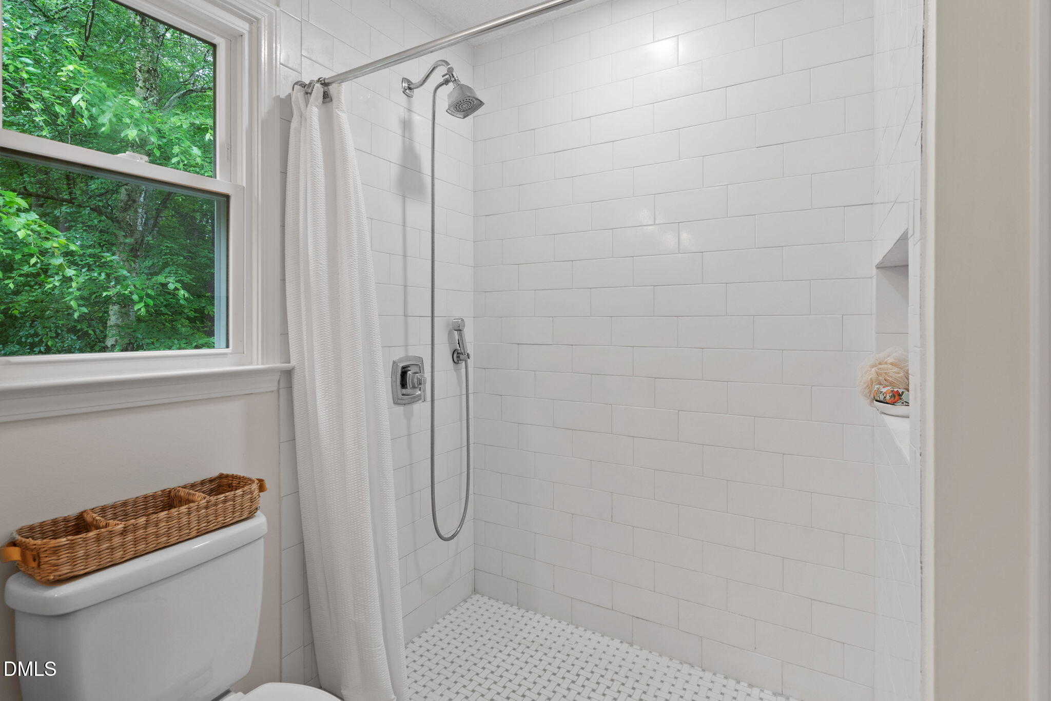 2724 Glastonbury Road Apex, NC 27539 - Photo 33 of 50 a bathroom with a shower a toilet and a window