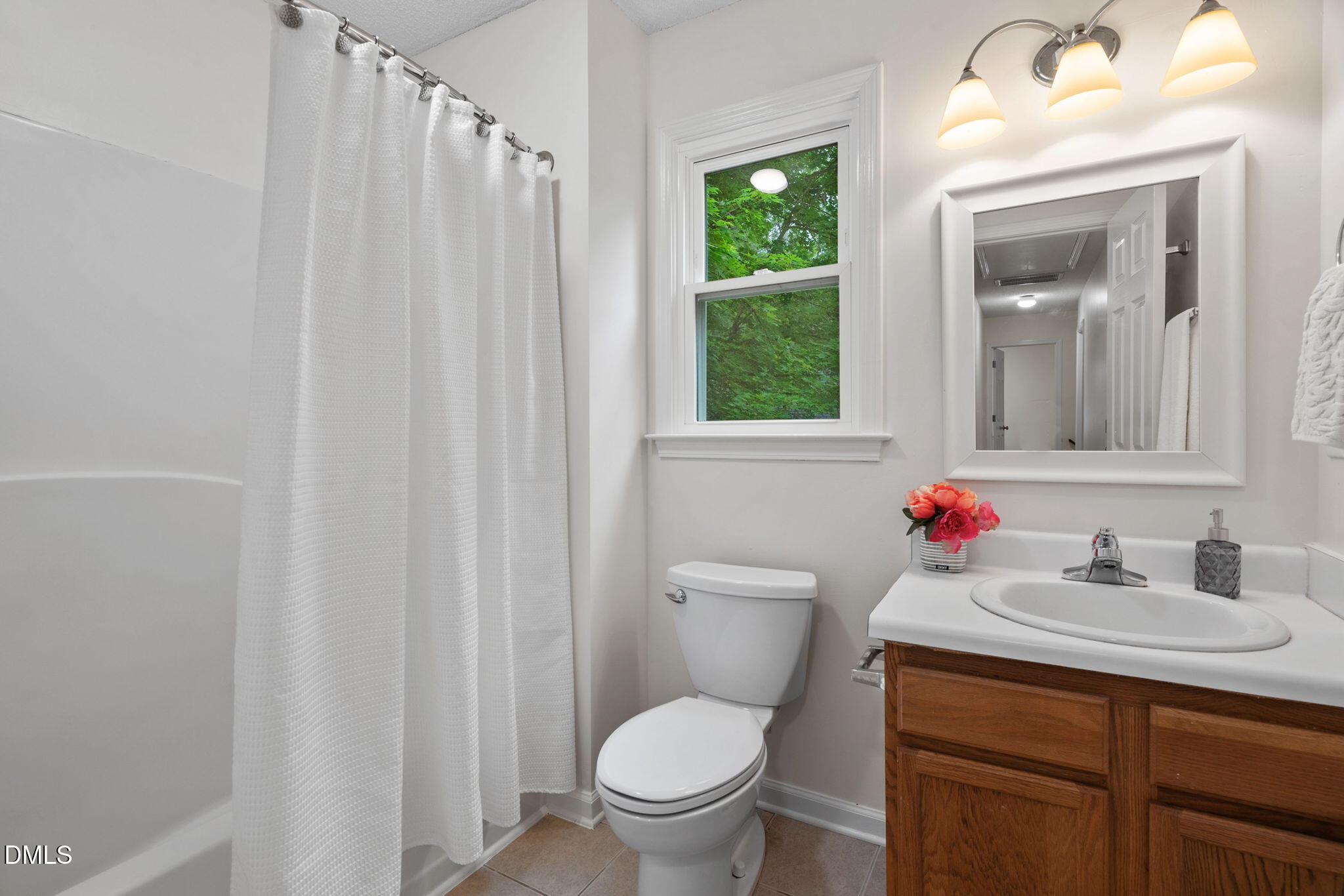 2724 Glastonbury Road Apex, NC 27539 - Photo 38 of 50 a bathroom with a toilet sink and mirror