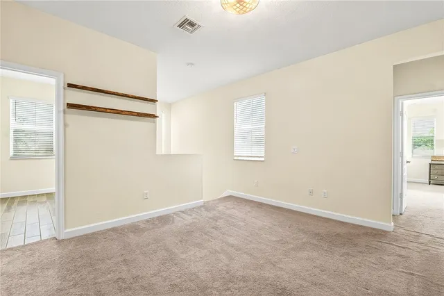 an empty room with windows and closet