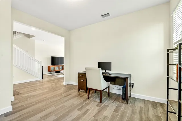 a view of a workspace with furniture and a window