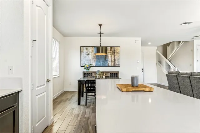 a kitchen with white cabinets and appliances