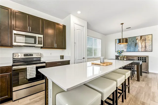 a kitchen with a stove a sink and a microwave