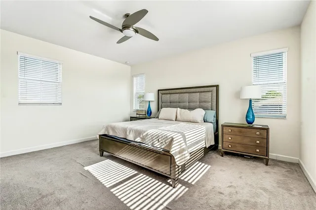 a bedroom with a bed dresser and a window