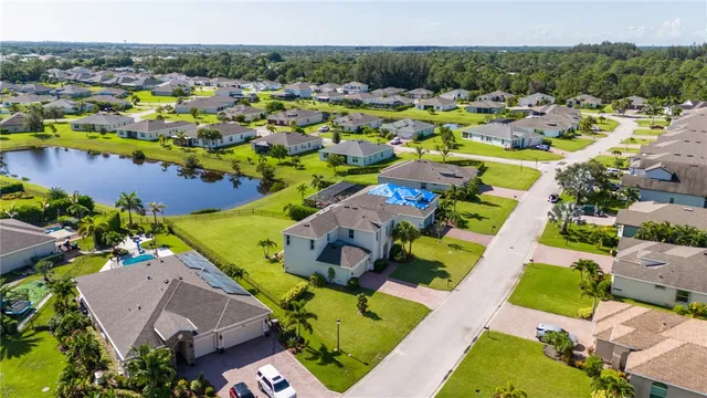an aerial view of a house with a swimming pool yard and outdoor seating