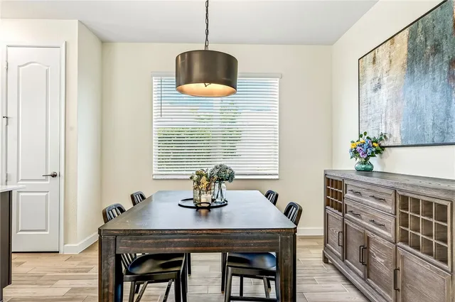 a dining room with furniture and window