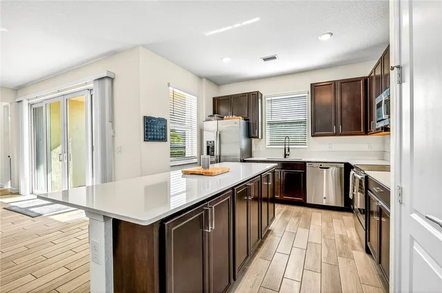 a kitchen with a stove sink and cabinets