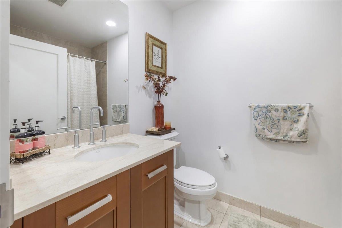 8100 River Road, Unit 209 North Bergen, NJ 07047 - Photo 15 of 42 a bathroom with a sink vanity mirror and toilet