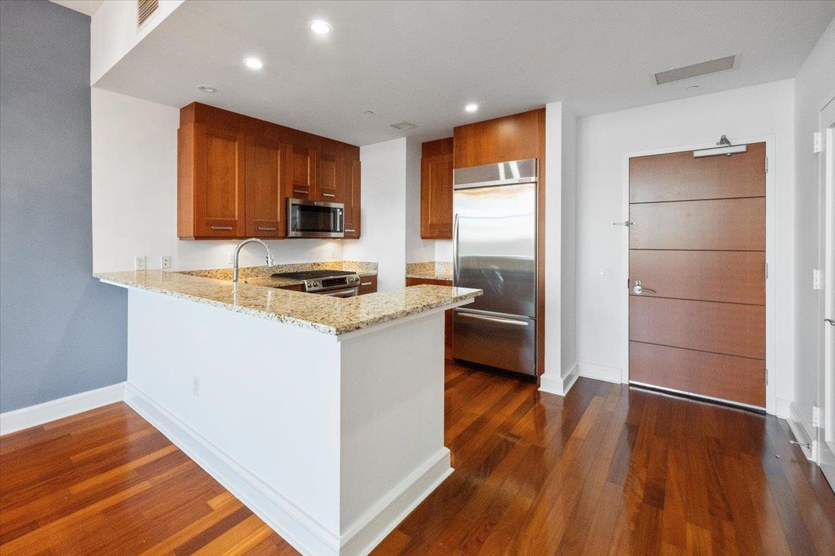 8100 River Road, Unit 209 North Bergen, NJ 07047 - Photo 2 of 42 a kitchen with stainless steel appliances a refrigerator and a stove top oven