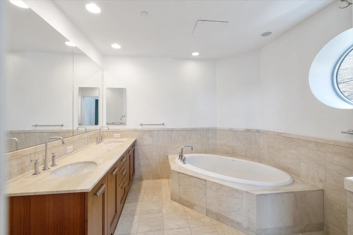 8100 River Road, Unit 209 North Bergen, NJ 07047 - Photo 26 of 42 a bathroom with a granite countertop sink and a bathtub