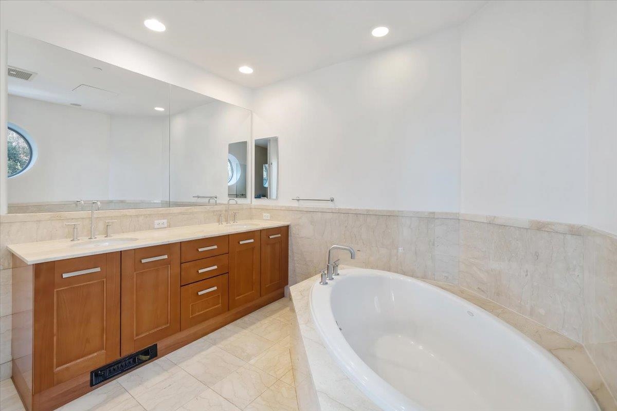 8100 River Road, Unit 209 North Bergen, NJ 07047 - Photo 27 of 42 a spacious bathroom with a granite countertop sink and a bathtub
