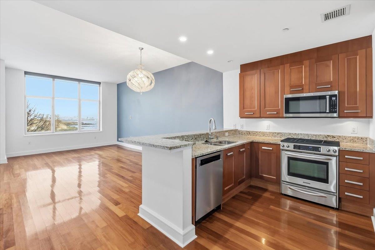 8100 River Road, Unit 209 North Bergen, NJ 07047 - Photo 4 of 42 a kitchen with granite countertop a stove top oven and a sink with granite countertops