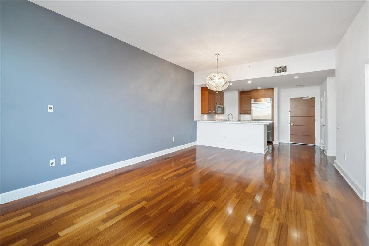 8100 River Road, Unit 209 North Bergen, NJ 07047 - Photo 6 of 42 a view of a kitchen with wooden floor and a sink