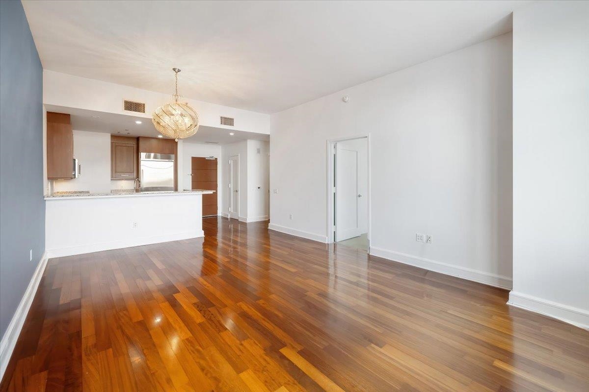 8100 River Road, Unit 209 North Bergen, NJ 07047 - Photo 7 of 42 wooden floor in an empty room with a window