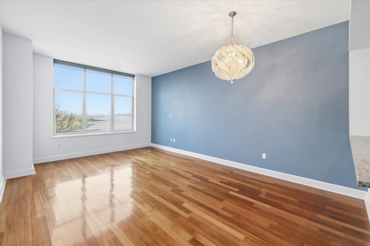 8100 River Road, Unit 209 North Bergen, NJ 07047 - Photo 8 of 42 wooden floor in an empty room with a window