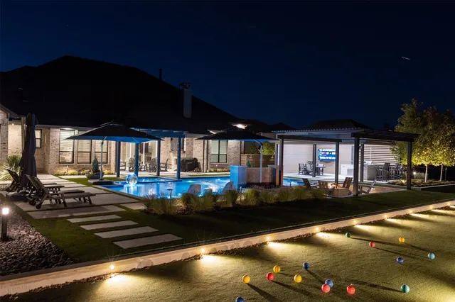 a view of a swimming pool with outdoor seating