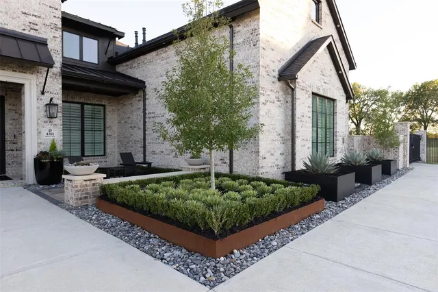 a front view of a house with garden