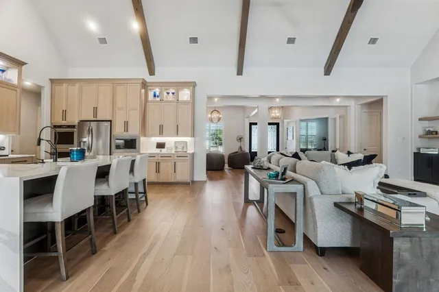 a living room with lots of furniture and white appliances