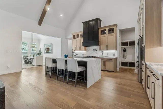 a large kitchen with a table and chairs