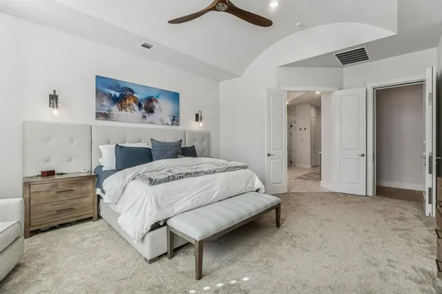 a bedroom with a bed and a painting on the wall