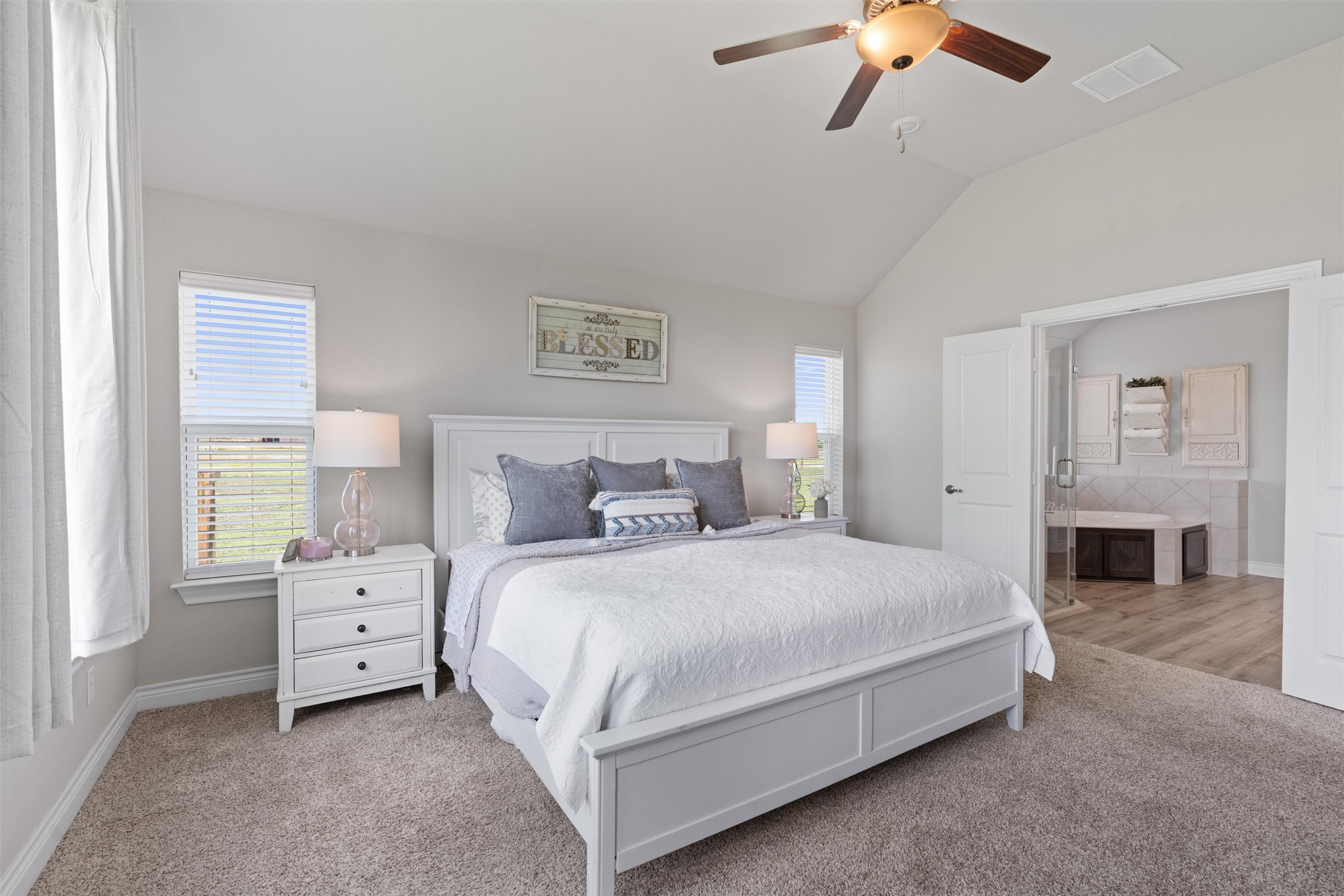4651 Fm 972 Georgetown, TX 78626 - Photo 14 of 40 a bedroom with a large bed and a chandelier