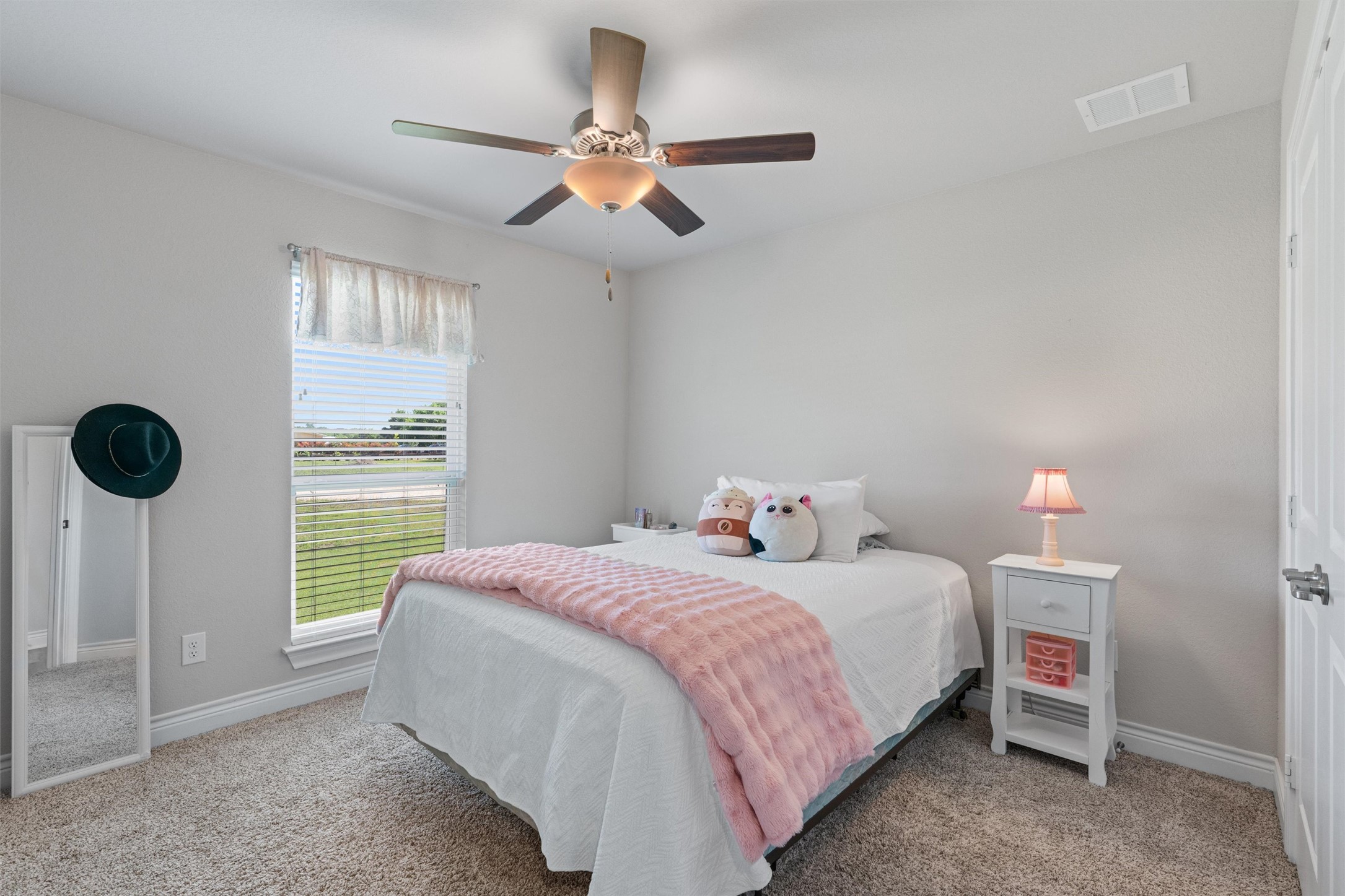 4651 Fm 972 Georgetown, TX 78626 - Photo 20 of 40 a bedroom with a bed and a fan