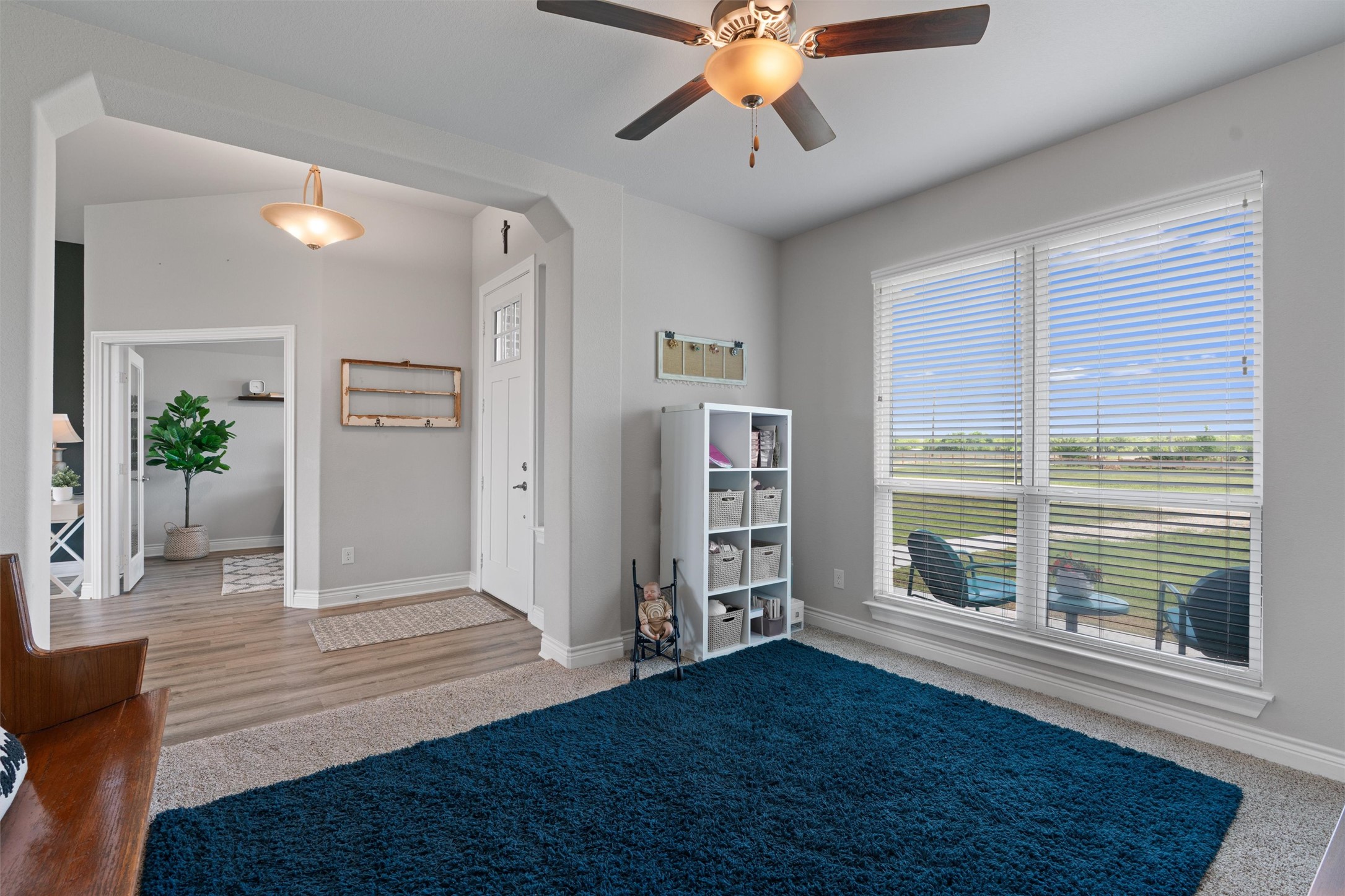 4651 Fm 972 Georgetown, TX 78626 - Photo 5 of 40 a view of a livingroom with wooden floor and a ceiling fan