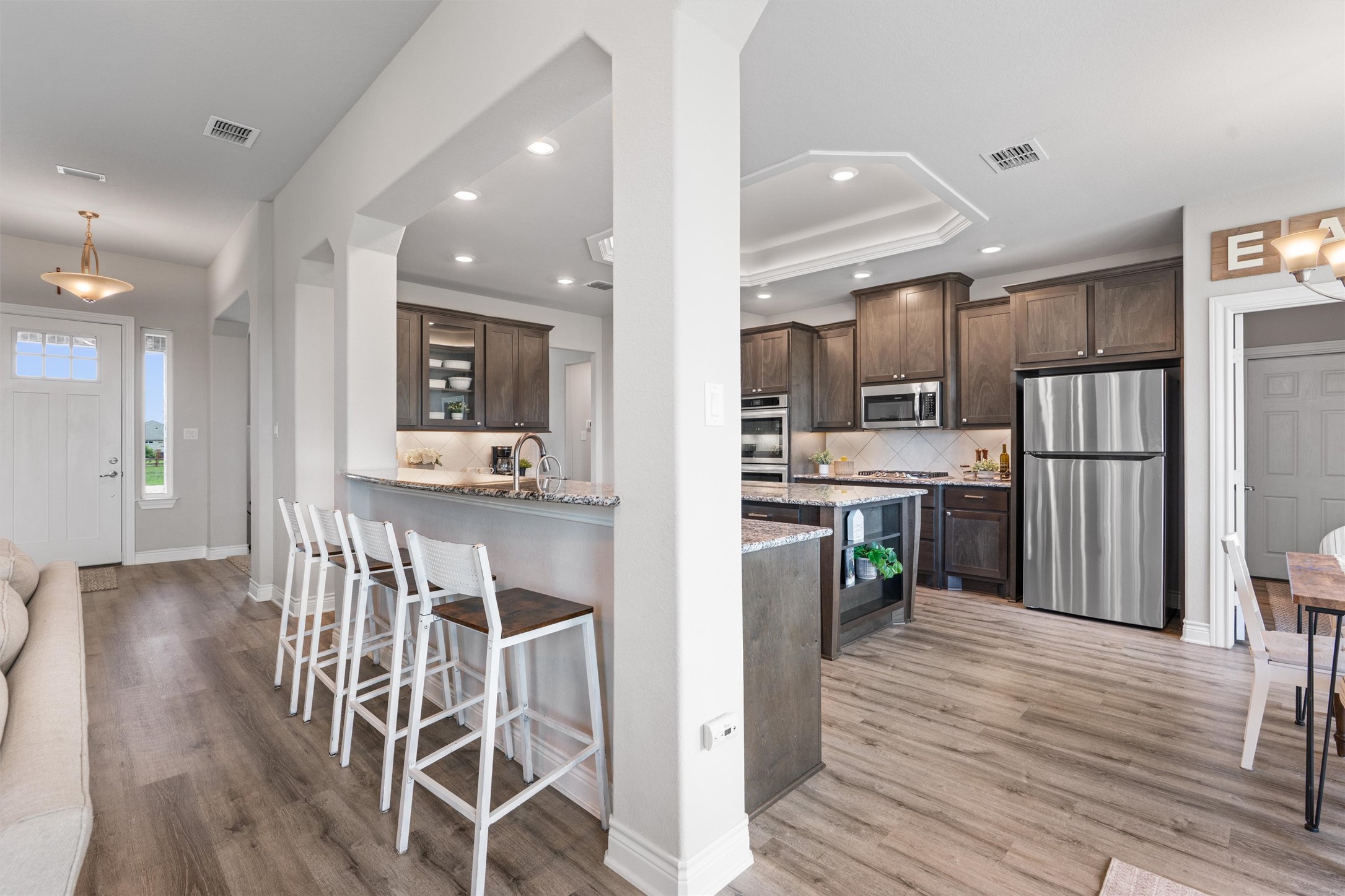 4651 Fm 972 Georgetown, TX 78626 - Photo 8 of 40 a view of kitchen with refrigerator microwave and wooden floor
