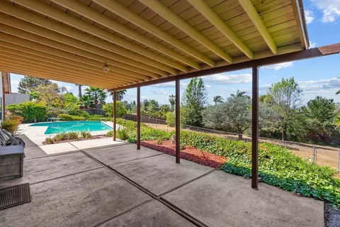 a view of backyard with patio
