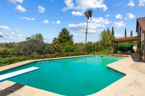 a view of a yard with swimming pool