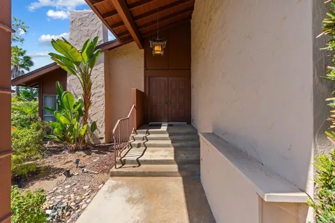 a house with a yard and a wooden bench