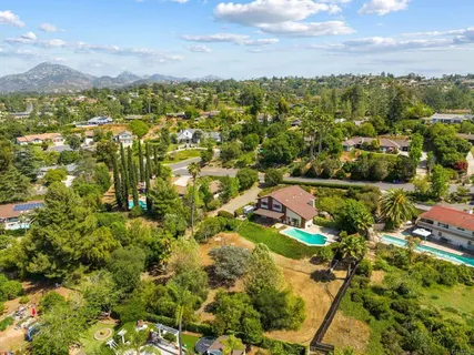an aerial view of residential house with outdoor space and swimming pool