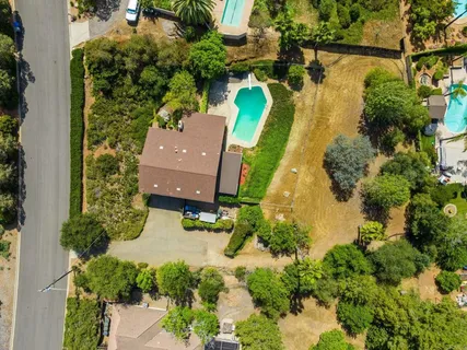 an aerial view of residential houses with outdoor space