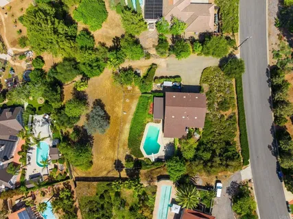an aerial view of a house with a yard and lake view