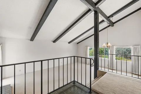 a view of staircase with lots of windows and wooden floor