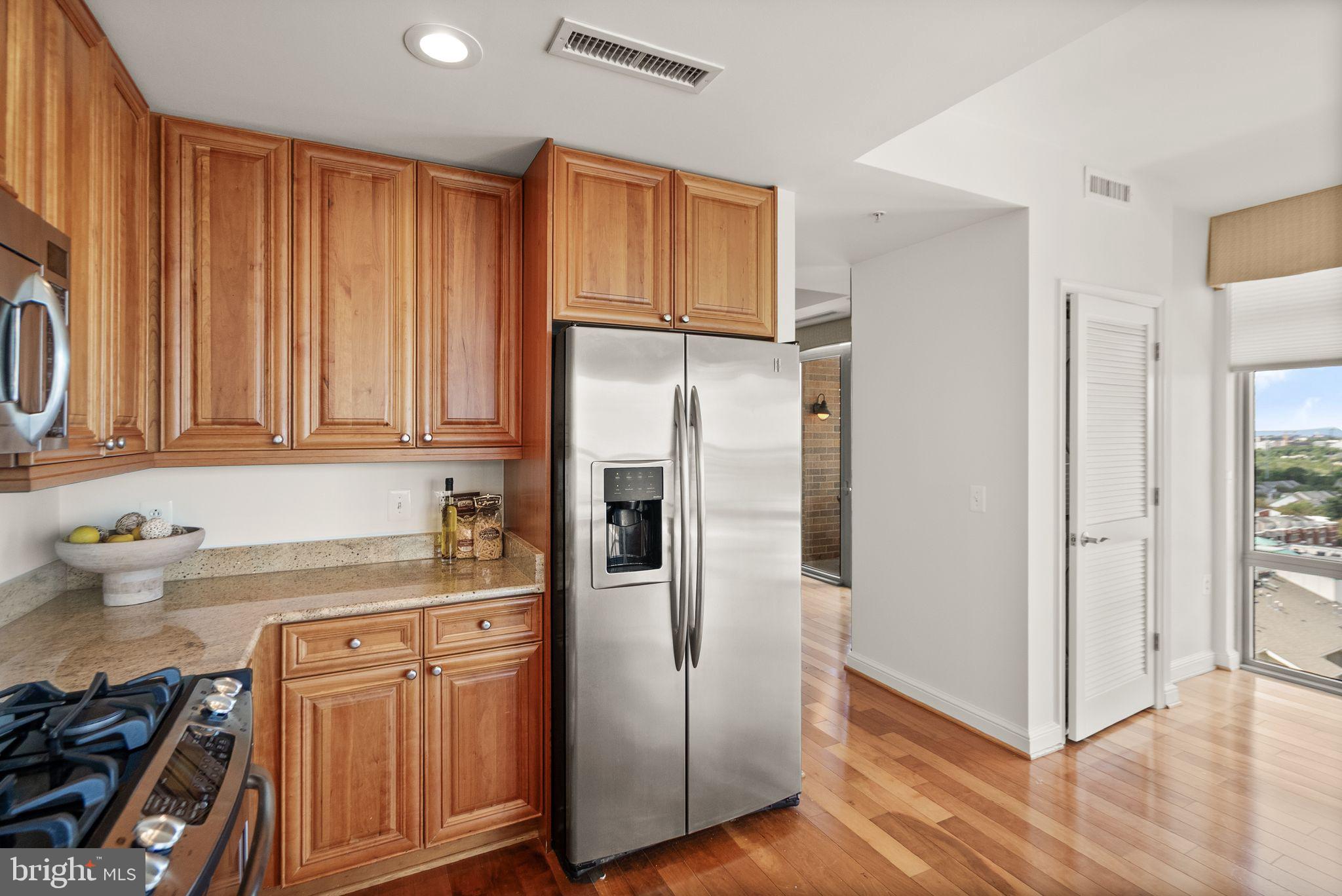 11990 Market Street, Unit 1015 Reston, VA 20190 - Photo 24 of 90 a kitchen with stainless steel appliances granite countertop a refrigerator and a sink