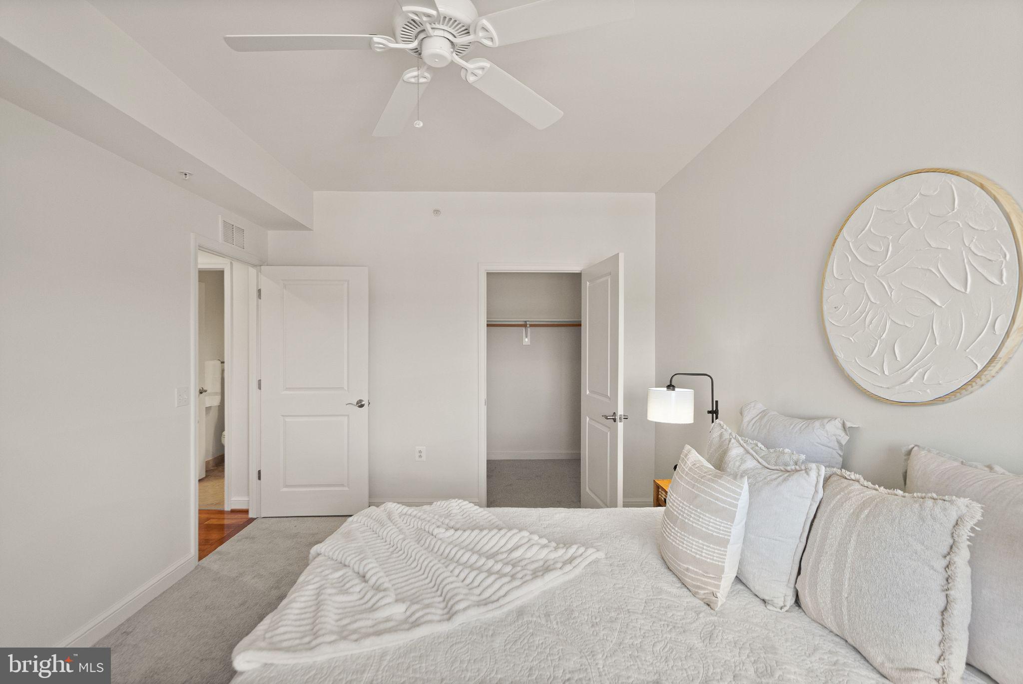 11990 Market Street, Unit 1015 Reston, VA 20190 - Photo 41 of 90 a bedroom with a bed and a chandelier