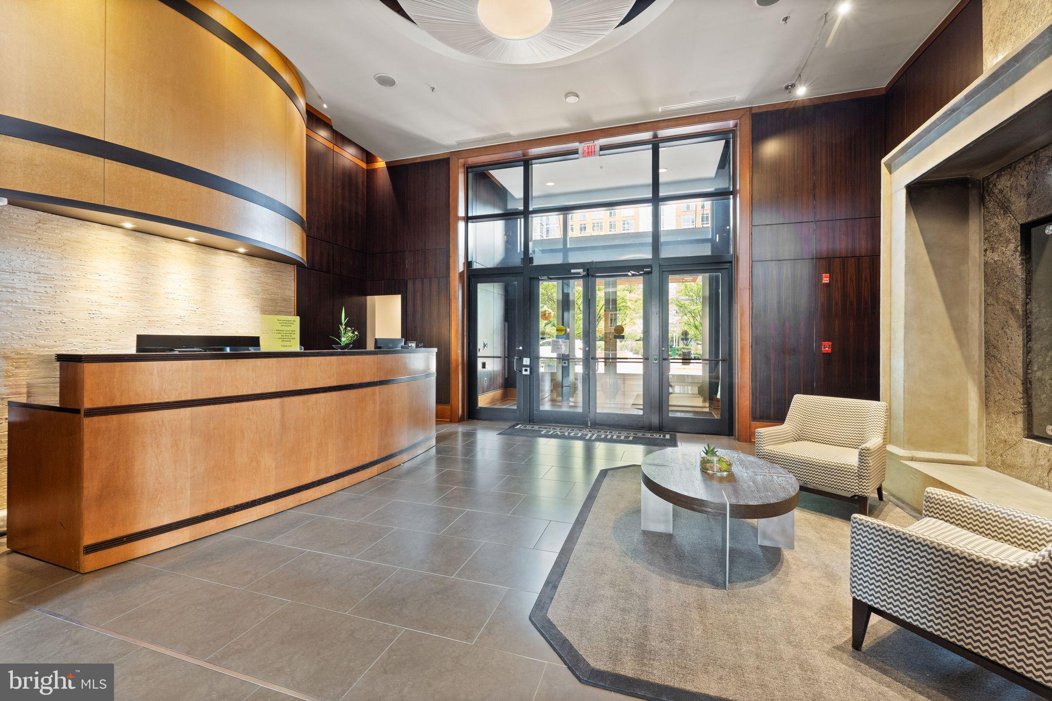 11990 Market Street, Unit 1015 Reston, VA 20190 - Photo 8 of 90 a lobby with furniture and floor to ceiling window