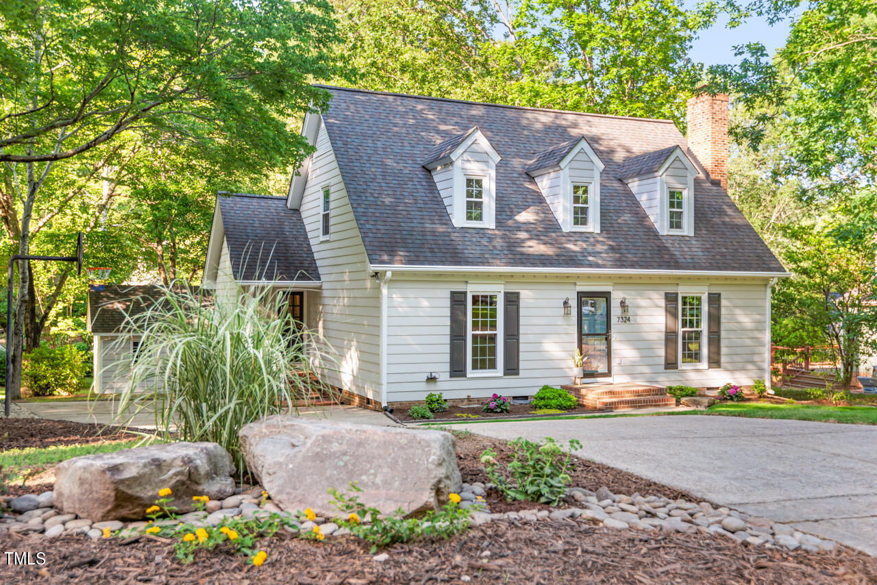 7324 Old Hundred Road Raleigh, NC 27613 - Photo 1 of 92 a front view of a house with garden and patio