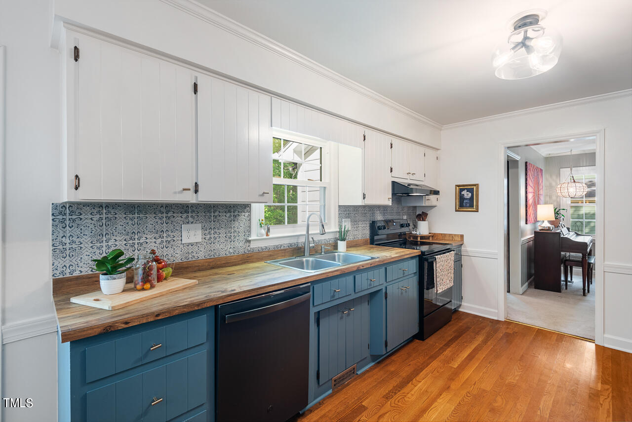 7324 Old Hundred Road Raleigh, NC 27613 - Photo 27 of 92 a kitchen with stainless steel appliances granite countertop a sink stove and cabinets