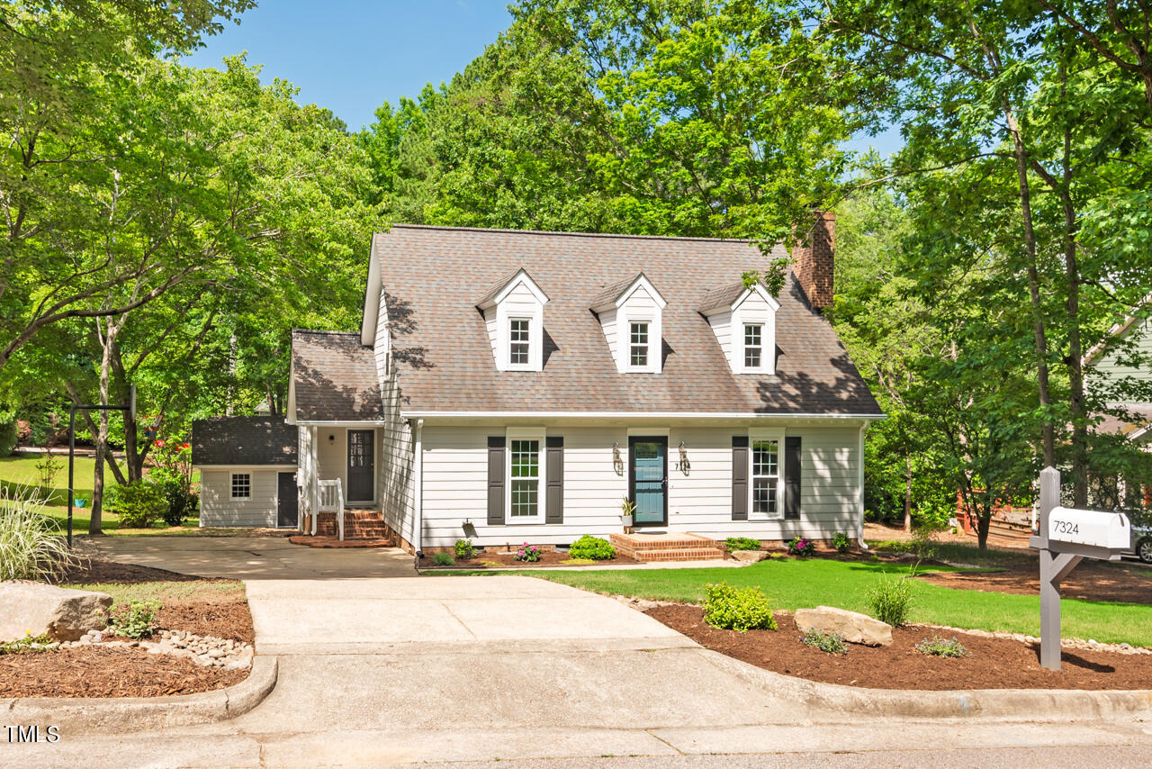 7324 Old Hundred Road Raleigh, NC 27613 - Photo 3 of 92 a front view of a house with a garden and tree