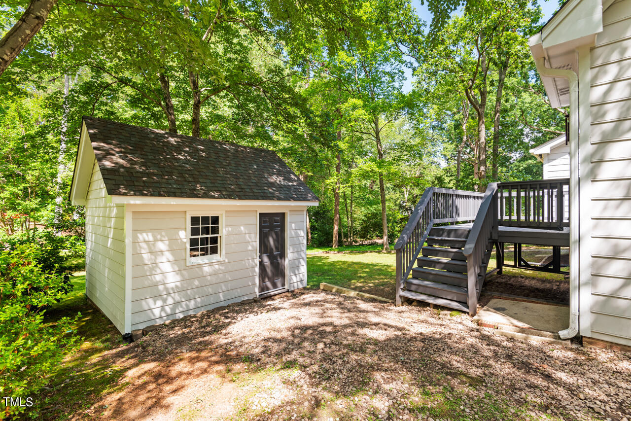 7324 Old Hundred Road Raleigh, NC 27613 - Photo 70 of 92 a view of a backyard with wooden fence and a large tree