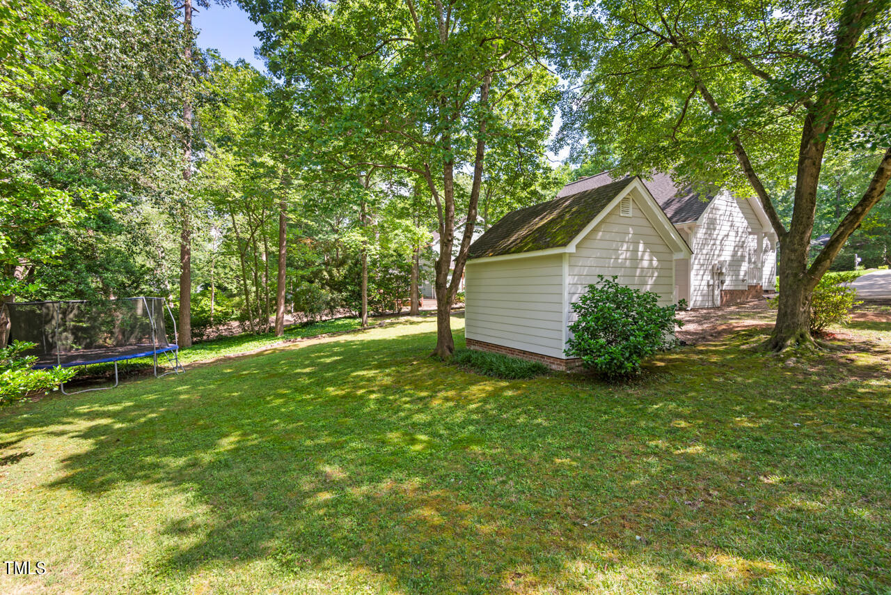 7324 Old Hundred Road Raleigh, NC 27613 - Photo 72 of 92 a view of a backyard with a large tree