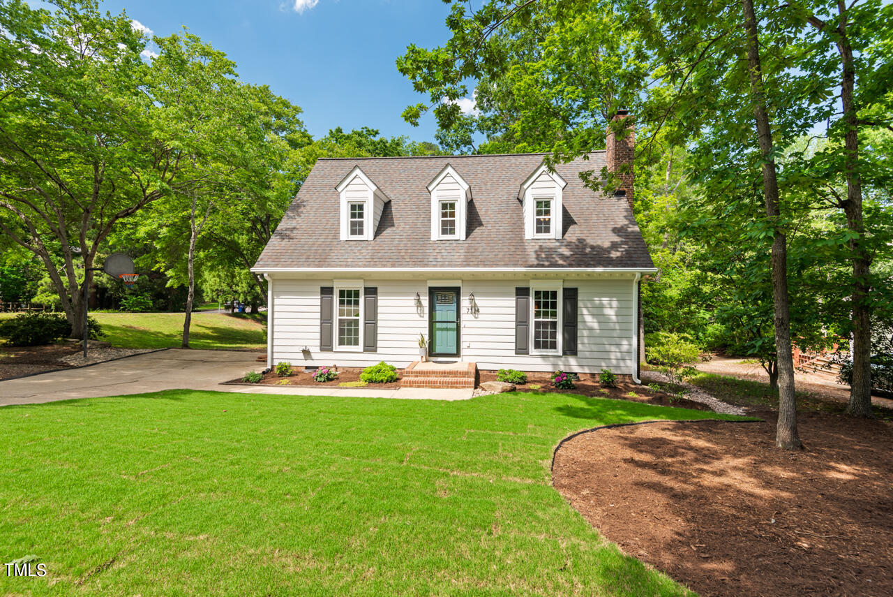 7324 Old Hundred Road Raleigh, NC 27613 - Photo 79 of 92 a front view of a house with a yard table and chairs