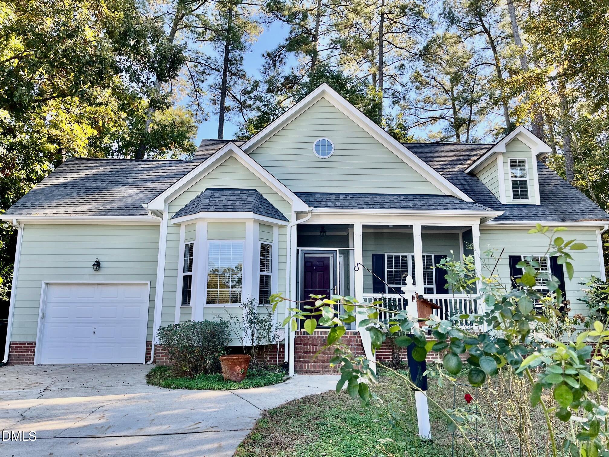 3027 Rennit Court Raleigh, NC 27603 - Photo 1 of 29 a view of a house with potted plants and a large tree