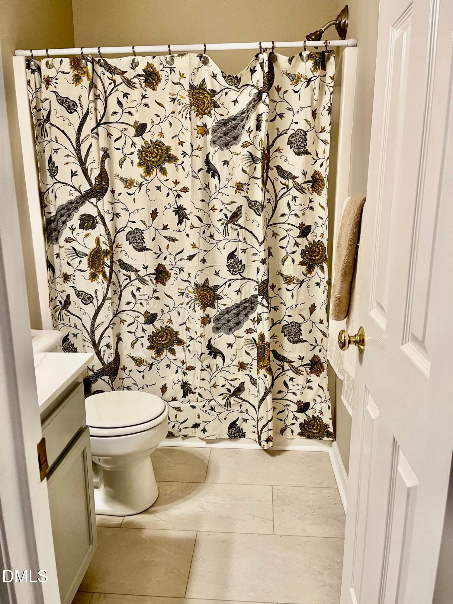 3027 Rennit Court Raleigh, NC 27603 - Photo 17 of 29 a white toilet sitting next to a shower curtain