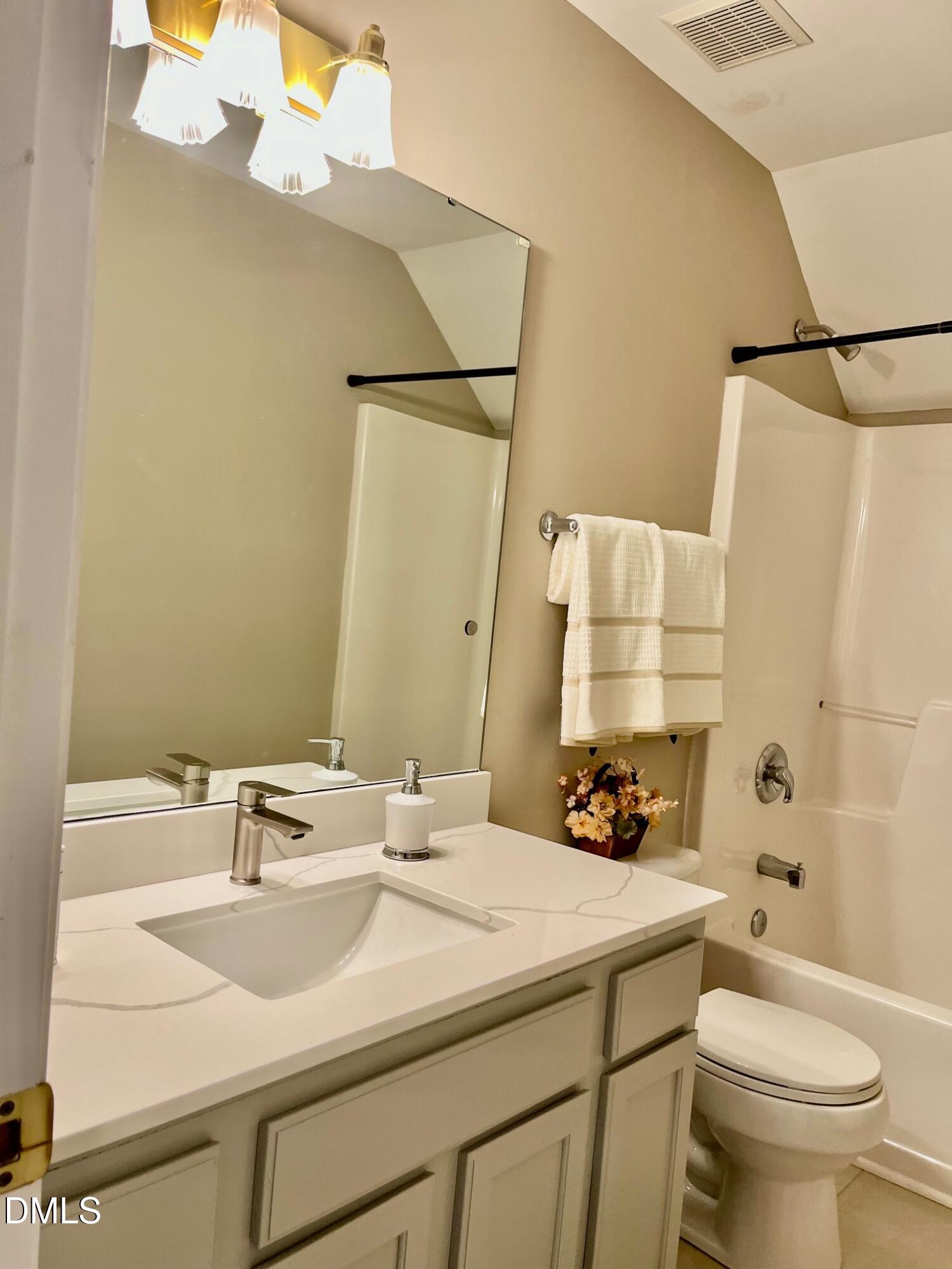 3027 Rennit Court Raleigh, NC 27603 - Photo 21 of 29 a bathroom with a sink and a mirror