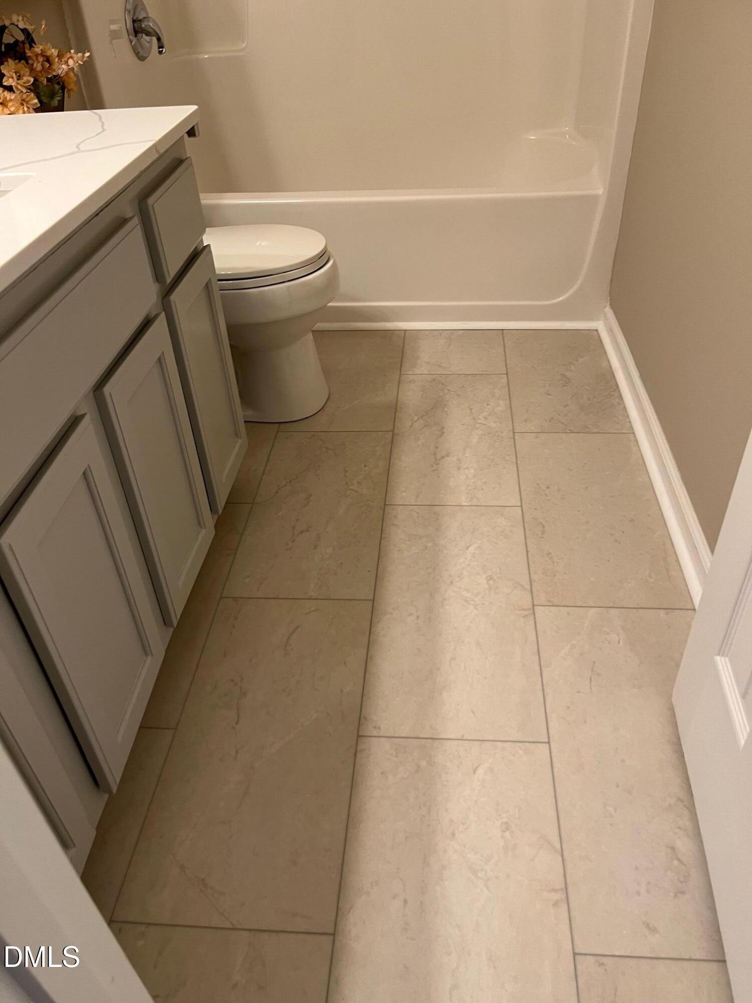 3027 Rennit Court Raleigh, NC 27603 - Photo 23 of 29 a bathroom with a toilet and a shower