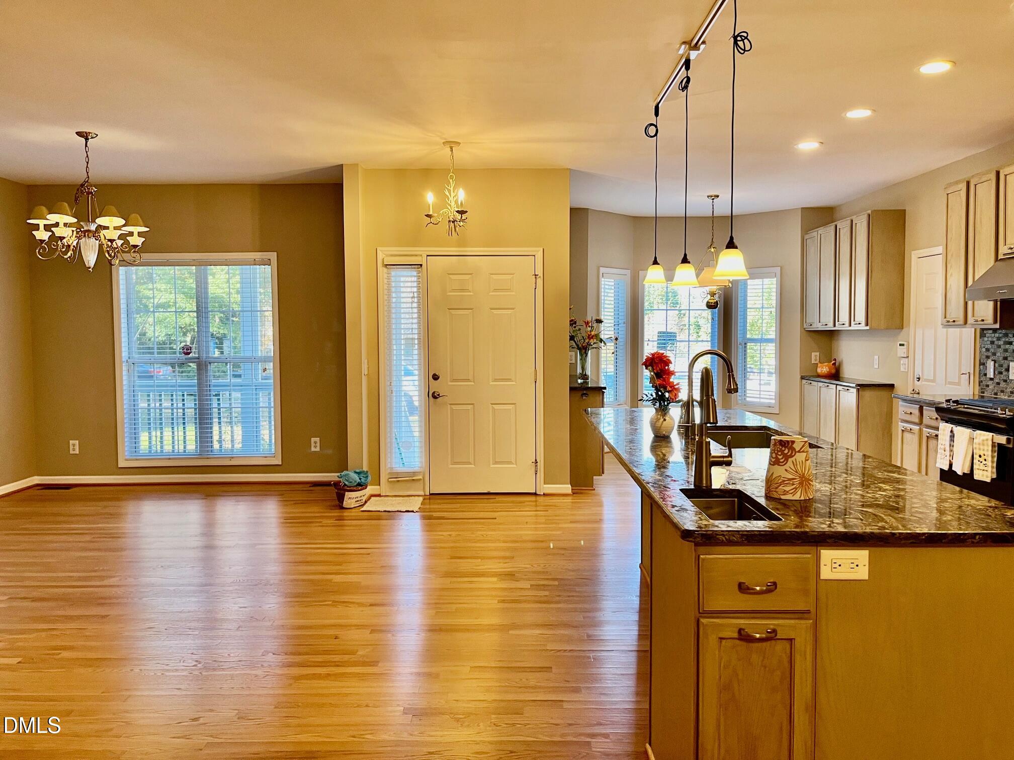 3027 Rennit Court Raleigh, NC 27603 - Photo 2 of 29 a kitchen with stainless steel appliances granite countertop a sink a stove and a wooden floors