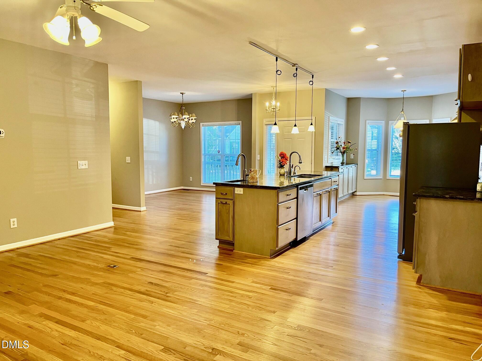 3027 Rennit Court Raleigh, NC 27603 - Photo 4 of 29 a view of a kitchen with kitchen island wooden floors stainless steel appliances