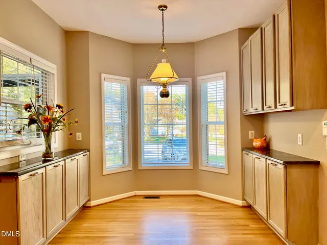a kitchen with stainless steel appliances granite countertop a stove a sink and a window